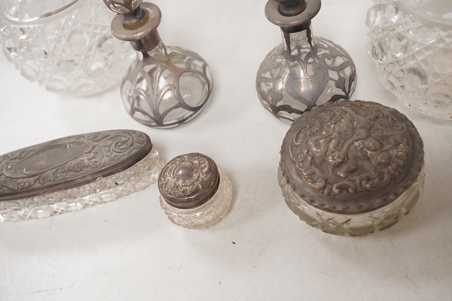 A pair of late Victorian silver mounted cut glass globular scent bottles, by C.C. May & Sons, Birmingham, 1898, height 11.8cm, together with three other silver mounted glass toilet jars and a pair of white metal overlaid